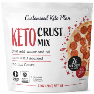 Front packaging of "Customized Keto Plan Keto Pizza Crust Mix" featuring a photo of a crispy keto pizza topped with pepperoni and melted cheese. The label highlights "2g Net Carbs" per serving and notes that it is low-carb, keto-friendly, non-GMO sourced, and made with no almond flour.